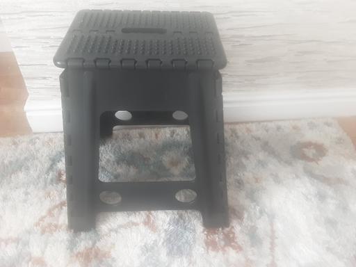 — Folding black step stool