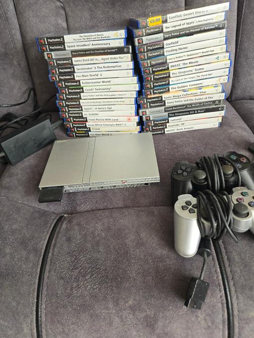  — slimline silver ps2 games and controller's