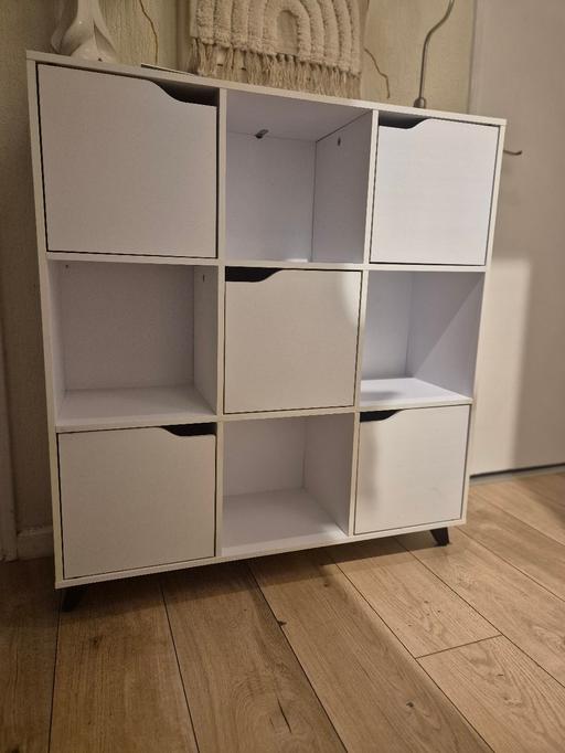  — This white cube storage unit is in good condi
