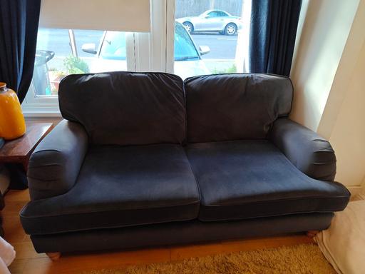  — Comfortable dark blue sofa with two cushions.