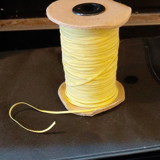 — 2mm wide sewing elastic, yellow on bobbin