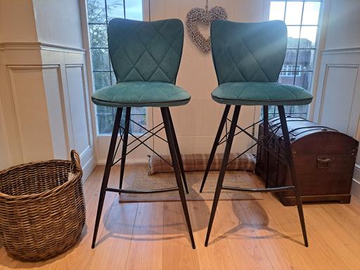  — Teal and black frame bar stools.