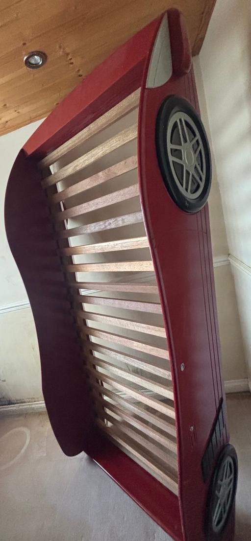  — A red children's racing car bed frame.