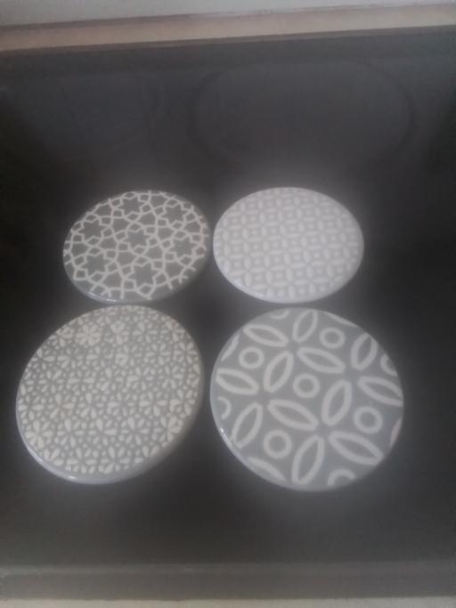  — FOUR BRAND NEW CERAMIC COASTERS