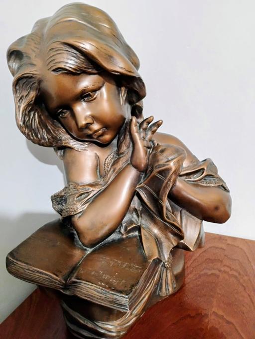  — bronze bust of girl  with music book on lap