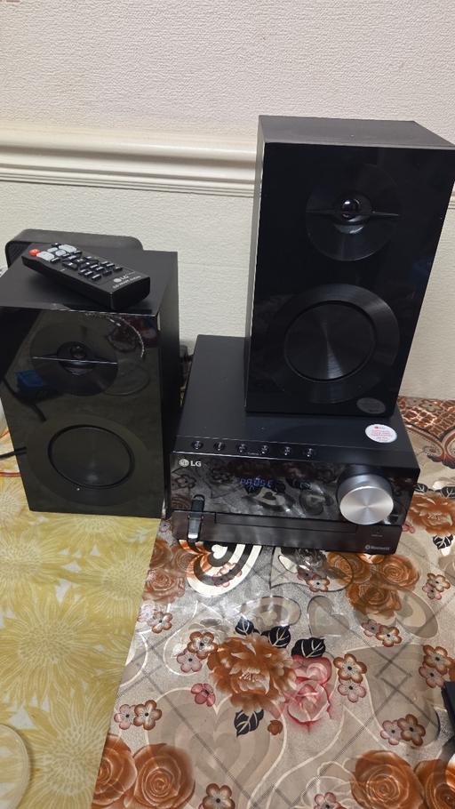  — LG stero system with speakers Bluetooth and a