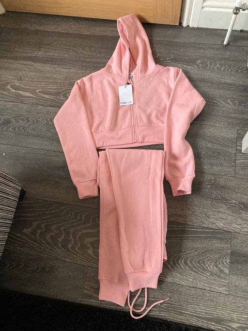  — Tracksuit