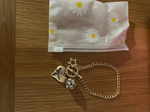  — Ladies gold-tone Guess charm bracelet